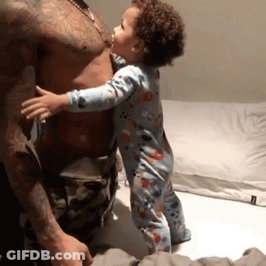 Baby Kissing Man's Chest On Bed GIF