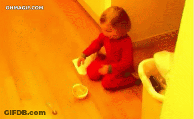 Baby Kneeling Near Trash Can And Food Bowl GIF