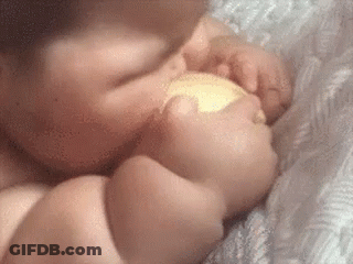 Baby Laying On Bed Eating Food GIF