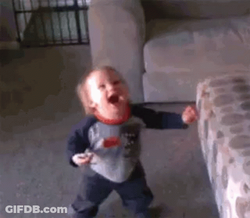 Baby Laying On Bed Making Funny Face GIF