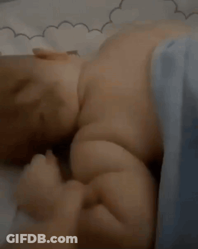 Baby Laying On Bed With Blue Blanket GIF
