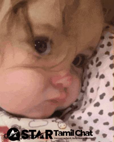 Baby Laying On Bed With Star Tamil Chat Logo GIF