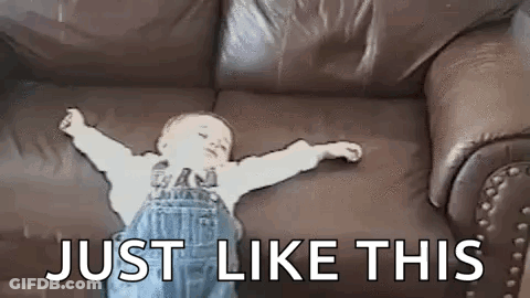 Baby Laying On Couch Arms Outstretched GIF