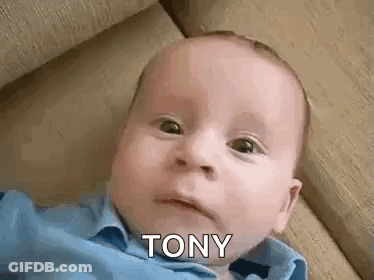 Baby Laying On Couch Making Funny Face Saying Tony GIF
