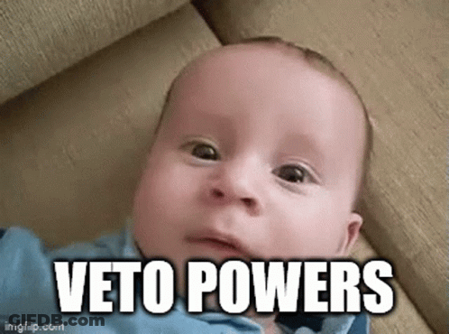 Baby Laying On Couch Making Funny Face Veto Powers GIF