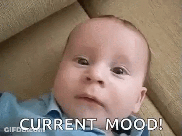 Baby Laying On Couch With Current Mood On Face GIF