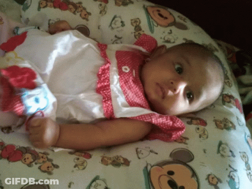 Baby Laying On Mickey Mouse Pillow GIF