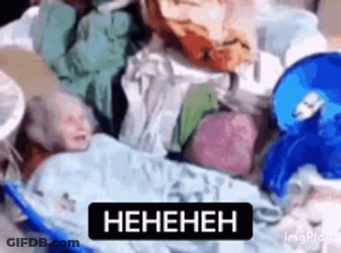 Baby Laying On Pile Of Clothes With Heneheneh Sign GIF