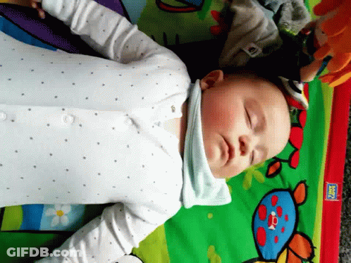 Baby Laying On Play Mat With Fisher Price Sticker GIF