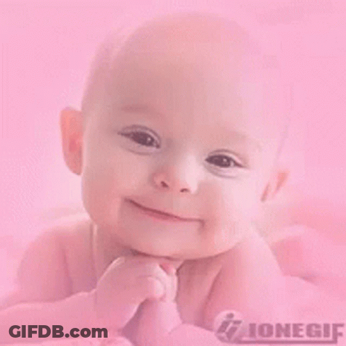 Baby Lying On Pink Blanket Smiling GIF