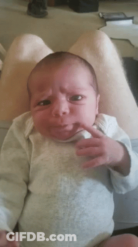 Baby Making Funny Face Held By Man GIF