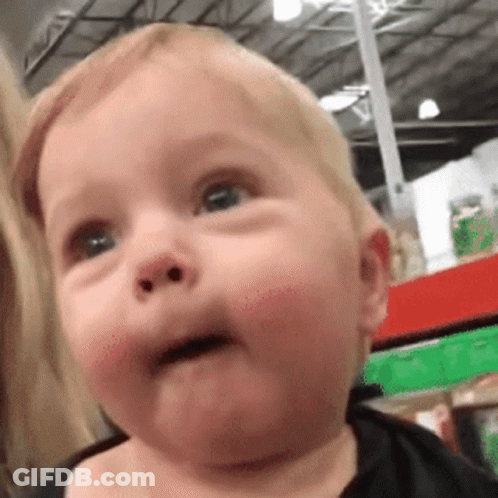 Baby Making Funny Face In Store GIF
