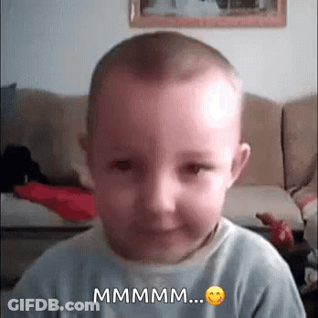 Baby Making Funny Face Saying Mmmm GIF