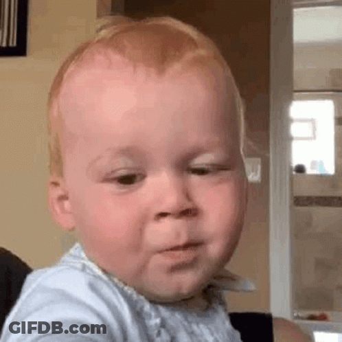 Baby Making Funny Face Sitting On Chair GIF