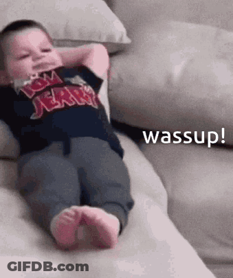 Baby On Couch With Hands Behind Head Saying Wassup GIF