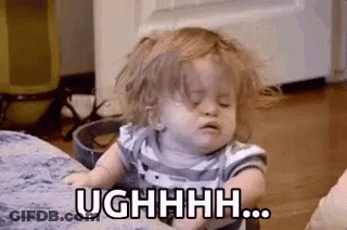 Baby On Couch With Messy Hair Making Face GIF