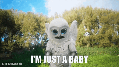 Baby Owl Says I'm Just A Baby In Front Of Trees GIF