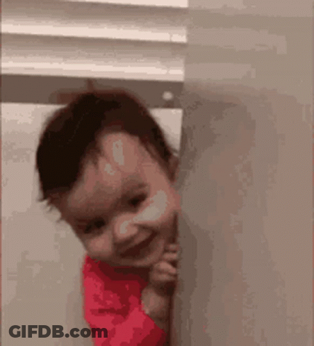 Baby Peeking From Behind Wall Smiling GIF