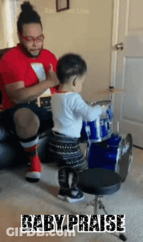 Baby Playing Drums With Man Behind GIF