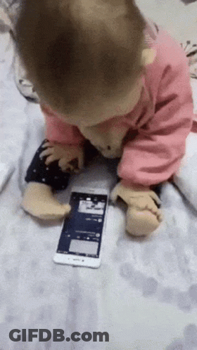 Baby Playing With Cell Phone On Blanket GIF