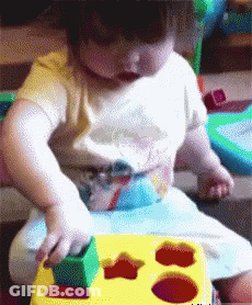 Baby Playing With Yellow Star Toy GIF