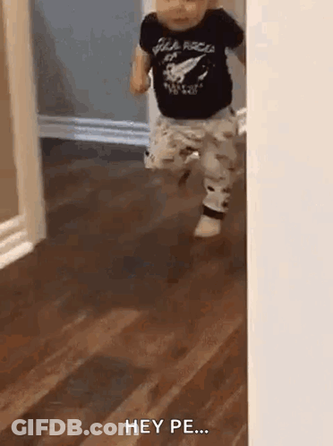 Baby Running Through Doorway In Black Shirt And Pants GIF