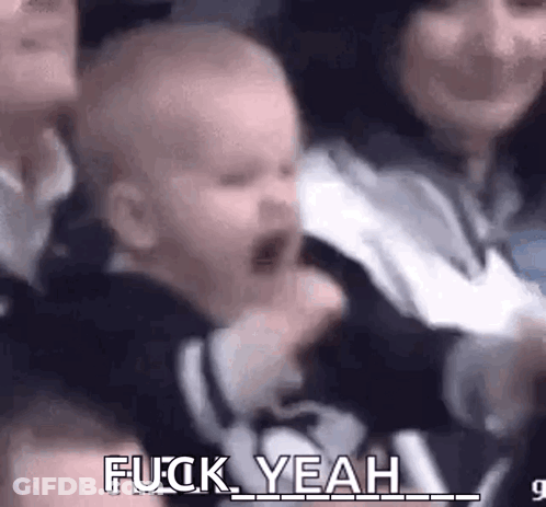 Baby Screaming In Crowd Held By Woman GIF