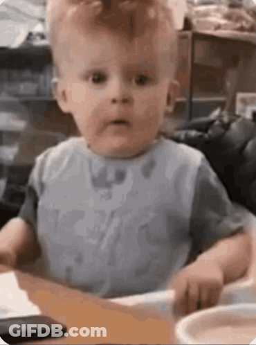 Baby Sitting At Table Making Funny Face GIF