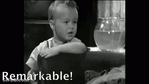 Baby Sitting At Table With Fish Bowl GIF