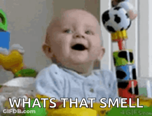 Baby Sitting In Crib With Toys And Whats That Smell GIF