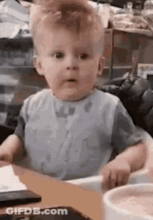 Baby Sitting In High Chair Making Funny Face GIF