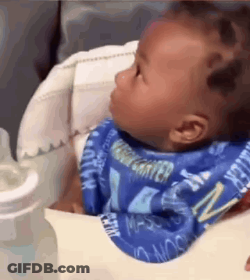 Baby Sitting In High Chair With Bib And Bottle GIF