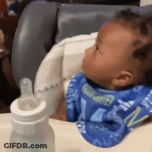 Baby Sitting In High Chair With Bib And Bottle GIF