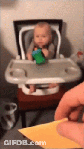 Baby Sitting In High Chair With Green Cup GIF