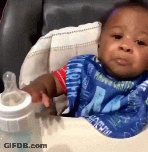Baby Sitting In High Chair With Milk Bottle GIF