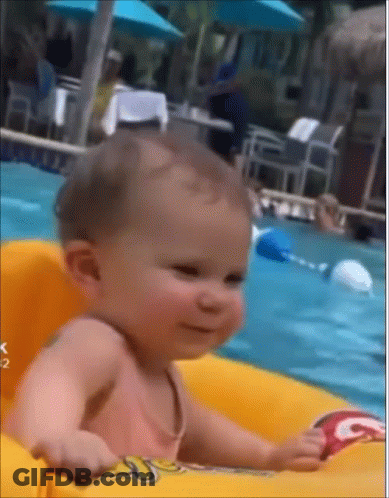 Baby Sitting In Inflatable Raft In Pool GIF