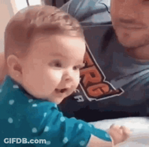 Baby Sitting Next To Man In Shirt GIF