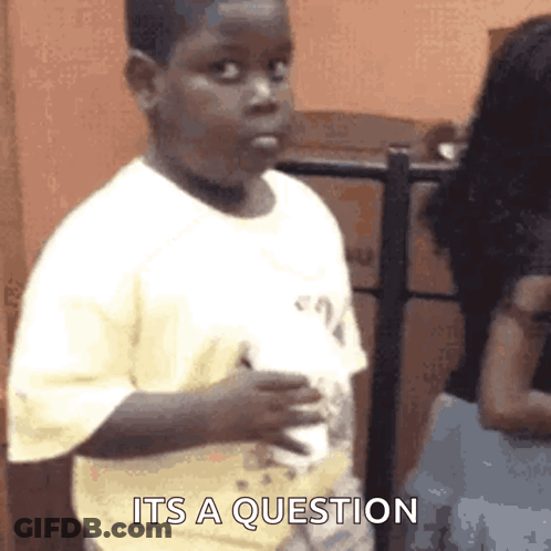 Baby Sitting On Bed Holding Birthday Present Saying Happy Birthday GIF