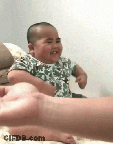 Baby Sitting On Bed With Person Holding Hand GIF
