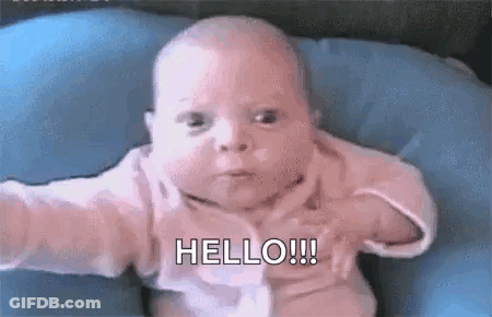 Baby Sitting On Blue Pillow Making Funny Face GIF