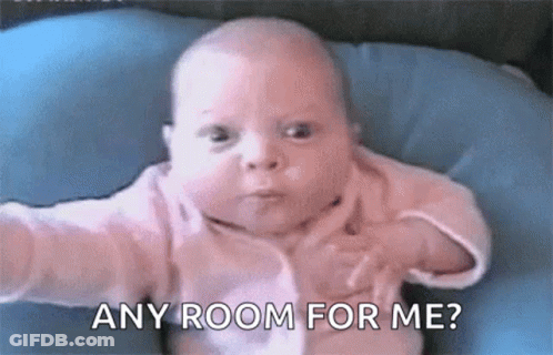 Baby Sitting On Blue Pillow Saying Any Room For Me GIF