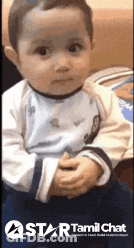 Baby Sitting On Couch In Front Of Star Tamil Chat Sign GIF