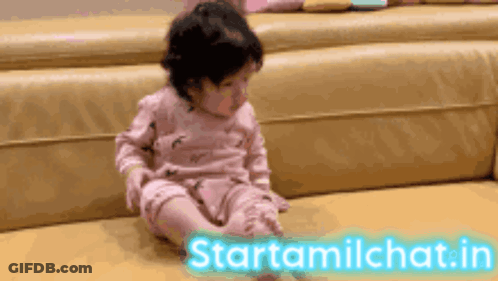 Baby Sitting On Couch Next To Starttamilchat Sign GIF