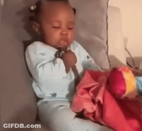 Baby Sitting On Couch With Blanket And Toy GIF