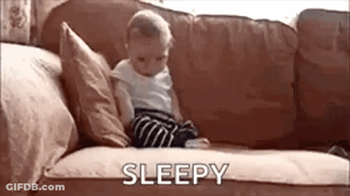 Baby Sitting On Couch With Sleepy GIF