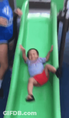 Baby Sliding Down Green Slide GIF