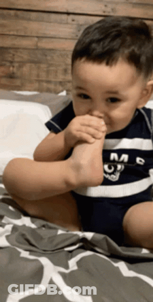 Baby Smelling Own Stinky Foot GIF