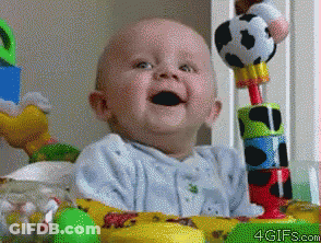 Baby Smiling In Crib With Toys GIF