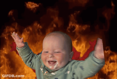 Baby Smiling In Front Of Flames GIF