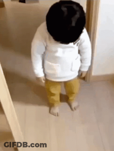 Baby Standing In Wooden Hallway GIF